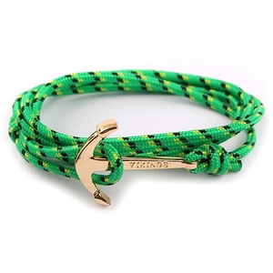 Detail of green and black nylon rope bracelet with gold viking anchor clasp