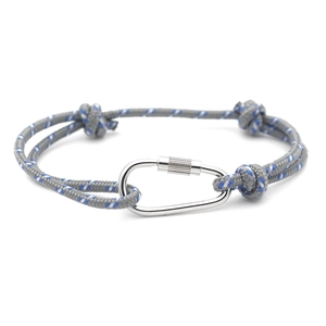 Detail of grey striped rope bracelet with silver metal carabiner buckle on white background