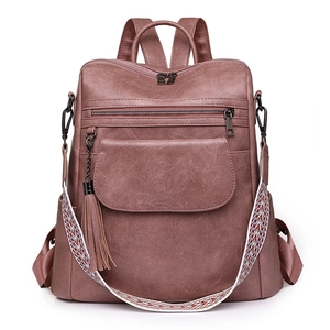 Vintage dusty pink PU leather backpack with a colorful woven strap and fringe tassel