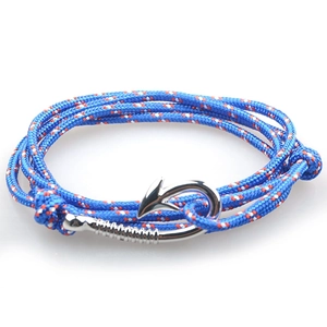 Close-up of blue nautical rope bracelet with silver fish hook clasp on white background