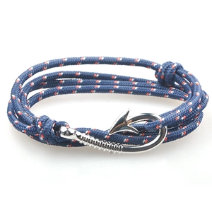 Detail of blue paracord braided bracelet with silver metal fish hook anchor clasp