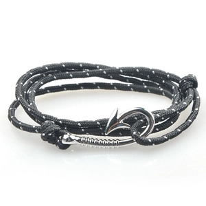 Detail of nautical multi-layer rope bracelet with silver anchor fish hook clasp