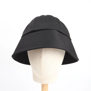 Close-up of a classic black cotton bucket hat texture on a neutral mannequin head display