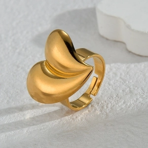 Minimalist irregular 18K gold heart-shaped open ring displayed on a white marble background