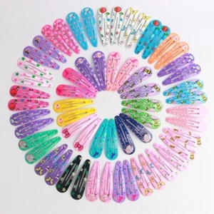 Detailed top view of colorful sequined heart and star pattern metal snap hair clips