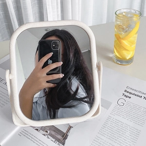 Minimalist beige tabletop makeup mirror with a rotatable stand and matte wheat fiber texture
