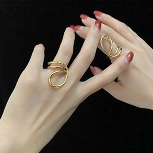 Macro shot of minimalist gold plated multi-layer open ring with sparkling zircon stones