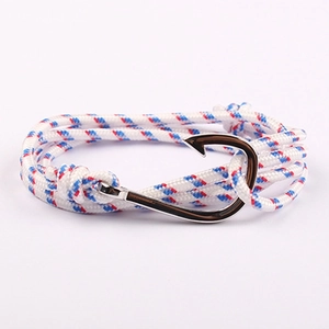 Detail of nautical rope bracelet with silver fish hook clasp on pink background
