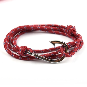 Close-up of red nautical braided rope bracelet with a silver metal fish hook clasp