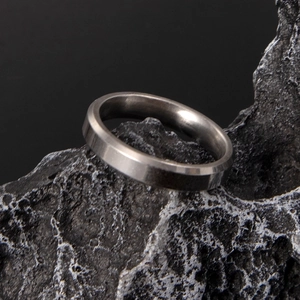 Macro detail of 6mm silver titanium steel ring with polished beveled edges and brushed finish