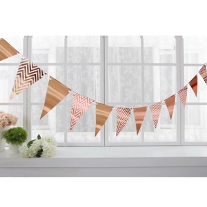 Detail of rose gold mirrored triangle bunting banners with chevron patterns for parties