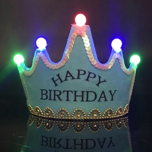Detail of blue LED birthday crown with five colored glowing lights and gold lace trim