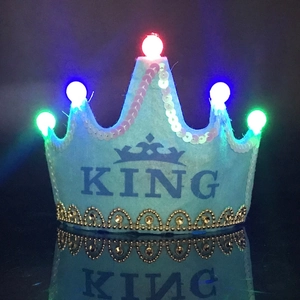Detail of light blue KING crown party hat showing glowing LED lights and gold sequins