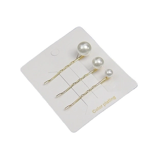 Three-piece set of minimalist gold wavy bobby pins with graduated white pearls