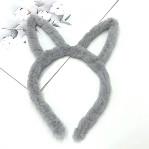 Detail of plush grey cat ear headband with soft faux fur texture on a minimalist background