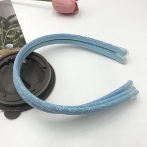 Close-up of light blue sequined double headband with protective tips on white background