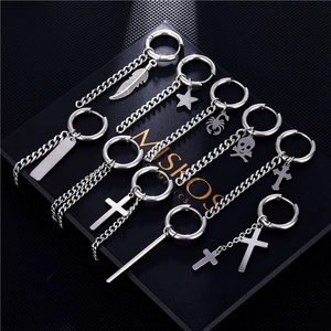 Set of seven silver punk cross and feather drop earrings on a black textured box