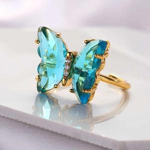 Macro shot of sky blue crystal butterfly ring with gold plating and adjustable band