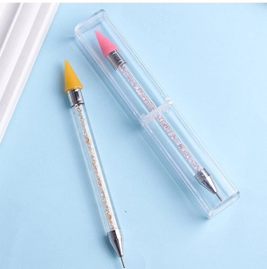 Dual-ended nail dotting pen set with acrylic handles and wax tips in a clear storage box