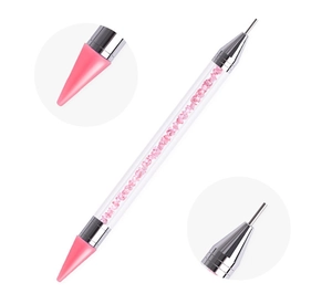 Detailed view of dual-ended nail dotting pen with pink wax tip and metal point