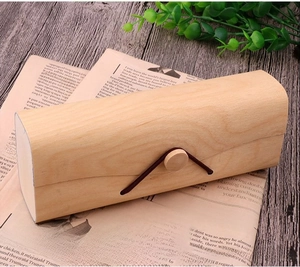 Detail of rustic bark-pattern wooden eyewear case with button and elastic cord closure