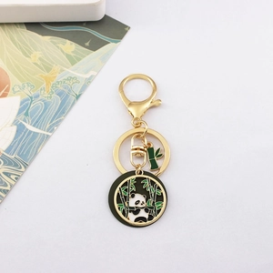 Cute panda keychain with bamboo charm in golden metal and enamel for bags and keys