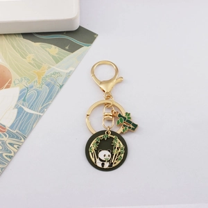 Detailed view of the cute panda and bamboo gold-plated metal keychain with enamel finish