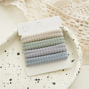 Set of four striped cotton scrunchies in beige, light green, purple, and blue colors