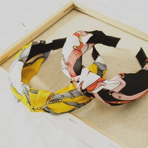 Wide satin knotted headband featuring elegant chain and belt prints for women