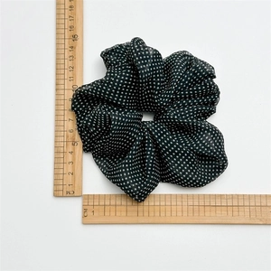 Polka dot mesh scrunchie in black and white with measurement ruler showing 11cm diameter