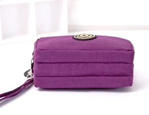 Deep purple washed nylon triple zipper pouch with hand strap and multiple layers