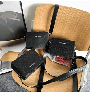 Detailed comparison of black box bags in smooth, crocodile, and ostrich leather textures