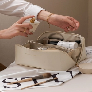 Large beige faux leather cosmetic bag with open compartment and internal organizers