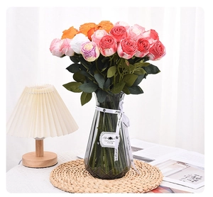 Artistic burnt-edge roses in a geometric gray glass vase for elegant home decor