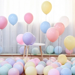 Close-up of pastel macaron balloons in pink, blue, and yellow for party decoration