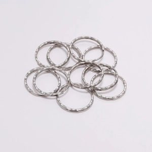 Detailed macro view of silver alloy 30mm split key rings with textured hammer finish surface