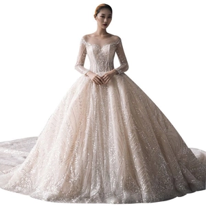 Elegant long sleeve ball gown wedding dress with sparkling sequins and sheer neckline