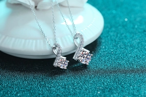 Macro shot of S925 sterling silver pendants with round cut stones on a textured background