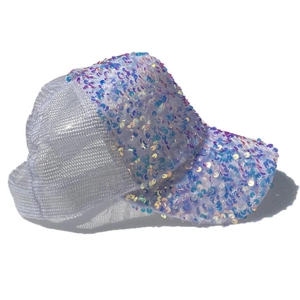 Detail of white mesh trucker hat featuring multi-color iridescent sequins on the visor