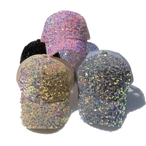 Detail of colorful sequin baseball caps showing breathable mesh and sparkling texture