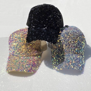 Detailed view of sequined baseball caps in black, silver and champagne with mesh back
