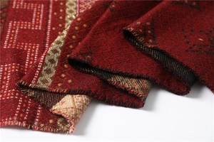 Macro view of geometric patterns and fringes on a thick rhombus lattice winter shawl