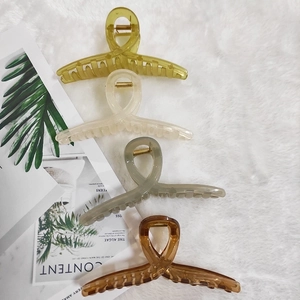 Set of four large jelly-colored hair claws in olive green, cream, grey and amber brown