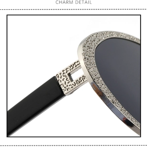 Macro shot of silver metal frame with intricate engraved textures on sunglasses hinge