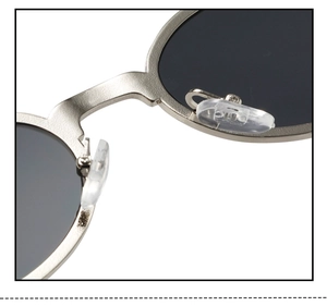 Detail shot of silver metal bridge and adjustable silicone nose pads on oval sunglasses