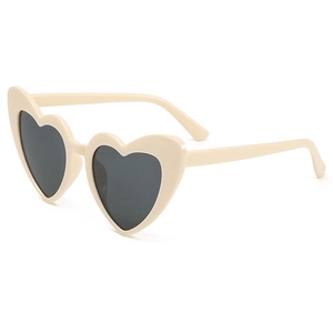Trendy cream heart shaped sunglasses with dark UV400 lenses in a stylish tilted view