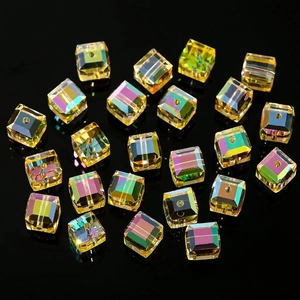 Macro shot of 4-8mm amber cube crystal beads with aurora AB coating on black background