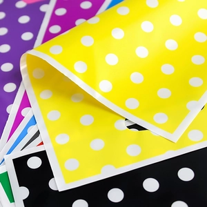Colorful polka dot party gift bags with die-cut handles for birthday candy packaging