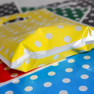 Yellow pearl film plastic gift bag with white polka dots for party candy packaging