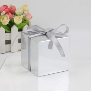 Square silver mirror gift box with satin ribbon bow on white decorative background